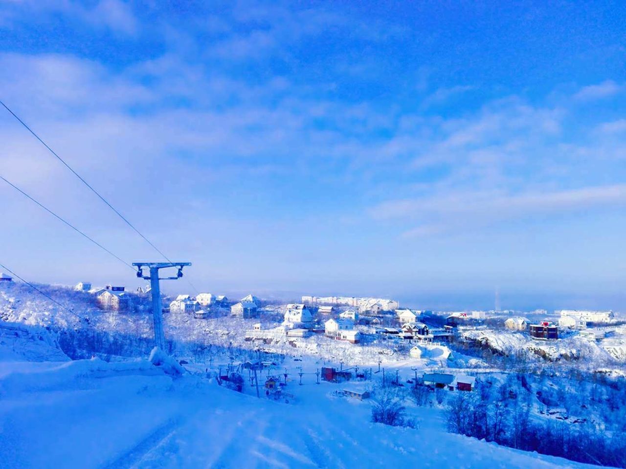 cold temperature, winter, snow, cable, sky, outdoors, power line, no people, blue, building exterior, nature, city, cloud - sky, built structure, illuminated, architecture, electricity, day, landscape, electricity pylon, scenics, telephone line, cityscape, ski lift