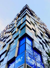 Low angle view of modern building against clear blue sky