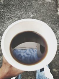 Directly above shot of man holding coffee