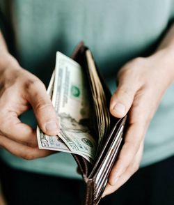Midsection of woman holding credit card