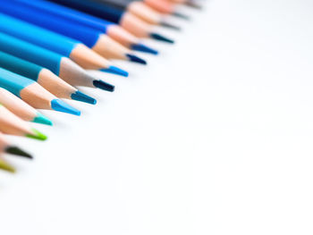 Close-up of colored pencils against white background