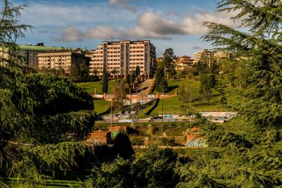 High angle view of trees and buildings against sky