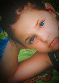 Close-up of young woman lying on bed at home