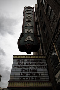 Low angle view of text on building against sky