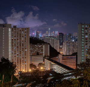 High angle view of illuminated buildings against sky at night