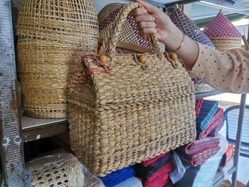 Cropped hand holding basket in store