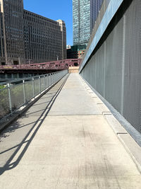 Footpath amidst buildings against sky in city