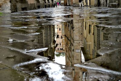 Reflection of buildings in puddle