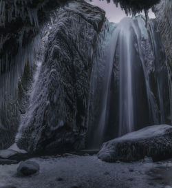 Scenic view of waterfall in forest during winter