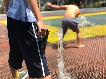 Boys playing by fountain