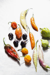 Various peppers on metal background