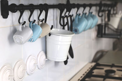 Interiors. wall in the kitchen with some blue cups in a row