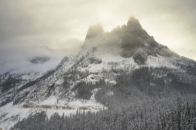 Moody backlit mountain peaks in the clouds