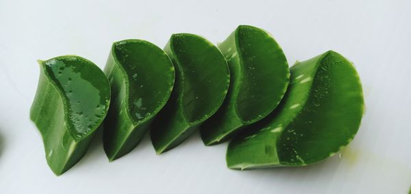 Close-up of green chili pepper against white background