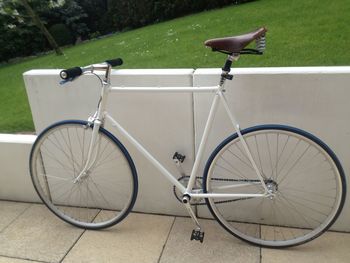 Bicycle parked against wall in city