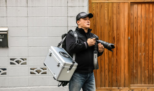 Full length of a man standing against the wall