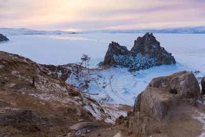 Scenic view of snowcapped mountains against sky during sunset