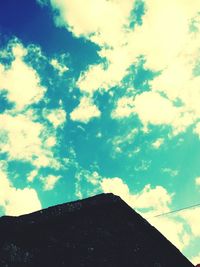 Low angle view of building against cloudy sky