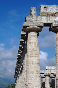 Low angle view of old ruins of temple against sky