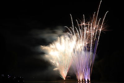 Low angle view of firework display at night