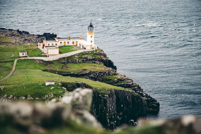 Lighthouse on cliff by sea