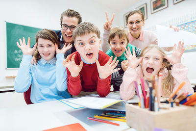 Portrait of people gesturing while shouting on table