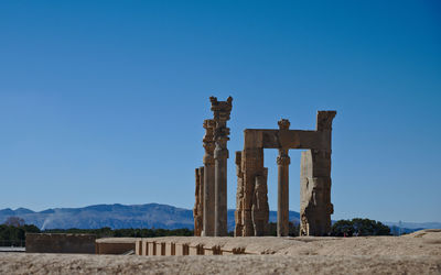 Old ruin structure against blue sky persepolis
