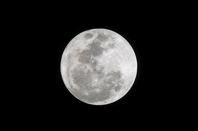 Low angle view of full moon against sky at night