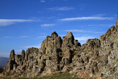 Low angle view of rock formations against sky