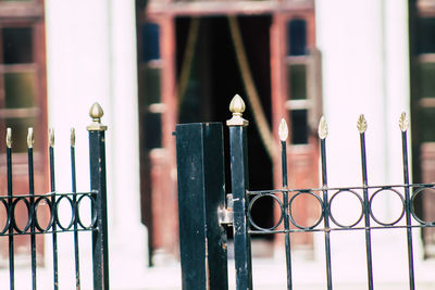 Close-up of metal gate against building