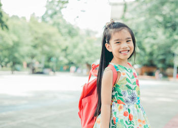 Portrait of smiling girl on tree