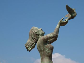 Low angle view of statue against clear blue sky