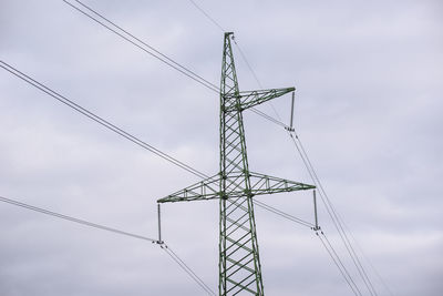 Low angle view of electricity pylon against sky