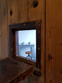 Old building seen through open door of house