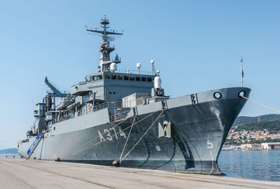 Ship moored at harbor against sky