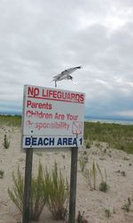 Close-up of signboard on beach