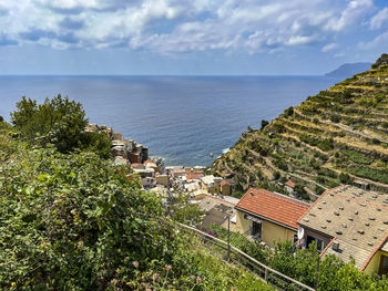 High angle view of townscape by sea against sky