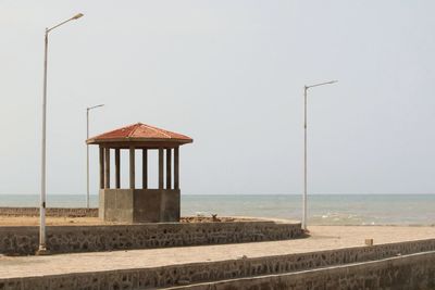 Lifeguard hut on beach against clear sky