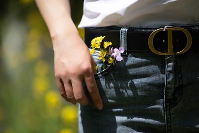 Midsection of person holding flower bouquet