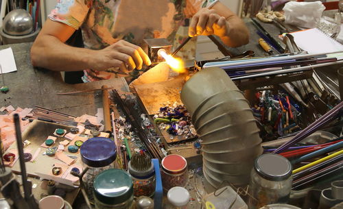 Midsection of man working in workshop