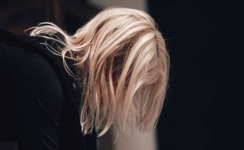 Close-up of woman with blond hair bending