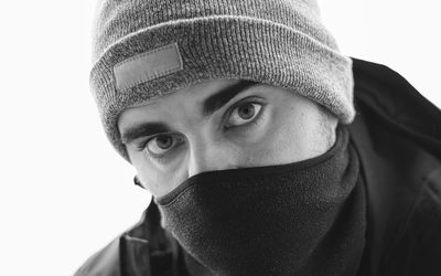Close-up portrait of man against white background