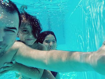 Father with daughters in swimming pool