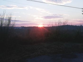 Scenic view of field against sky during sunset