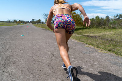 Rear view of woman on road