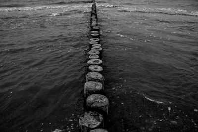 High angle view of wooden posts in sea