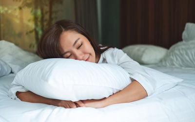 Young woman sleeping on bed