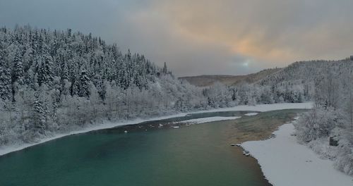 Scenic view of lake against sky during winter