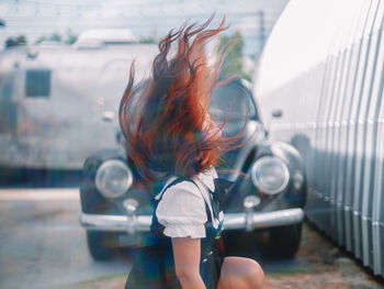 Rear view of woman looking through window