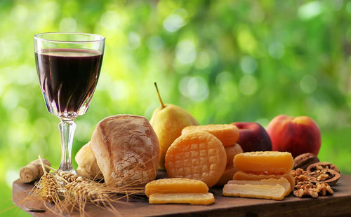 Fruits and wineglass on table